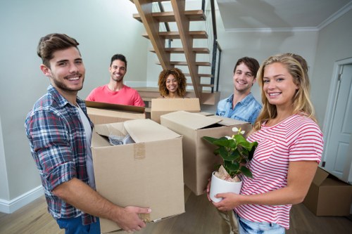 Removal crew handling furniture in a Norwegian property
