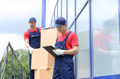 Moving team handling household items outside a Norwegian home